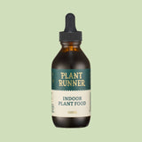 Bottle of Plant Runner indoor plant food on a light green background