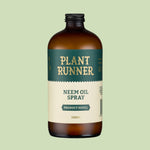 Brown bottle of Plant Runner Neem Oil Spray on a light green background