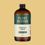 Bottle of Plant Runner Neem Oil Spray on a beige background