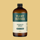 Bottle of Plant Runner Neem Oil Spray on a beige background