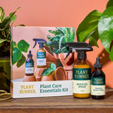Plant Runner plant care essentials kit_bottles and packaging on a wooden surface.