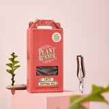 A Box of The Plant Runner's Cacti potting mix set amongst garden accessories